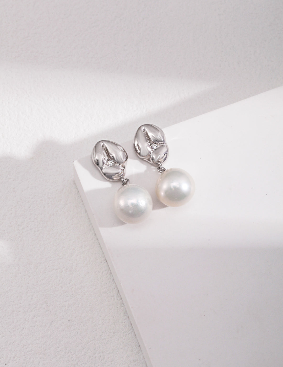 Playful Silver Pearl Earrings with Zircon Accent